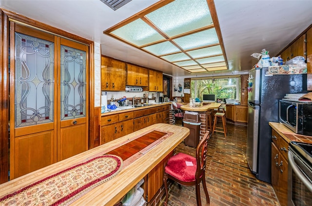 kitchen with sink and appliances with stainless steel finishes