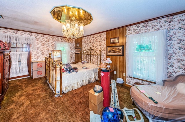 bedroom featuring an inviting chandelier, crown molding, a textured ceiling, and dark colored carpet