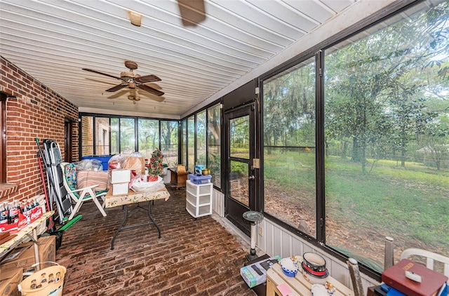 unfurnished sunroom with a wealth of natural light and ceiling fan