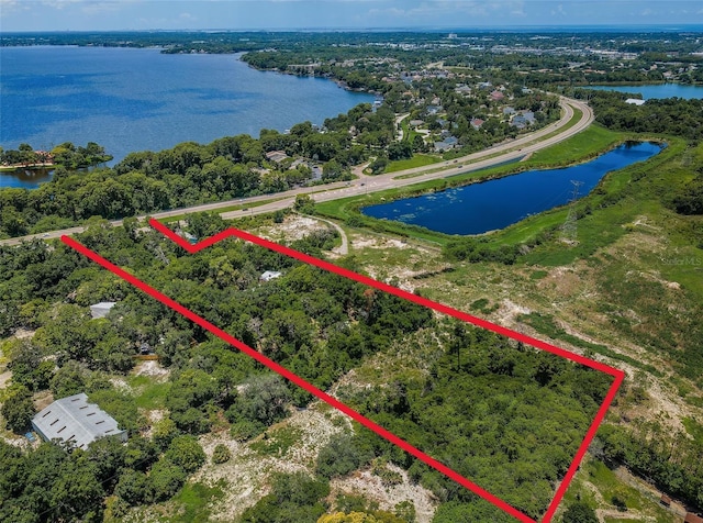 birds eye view of property with a water view