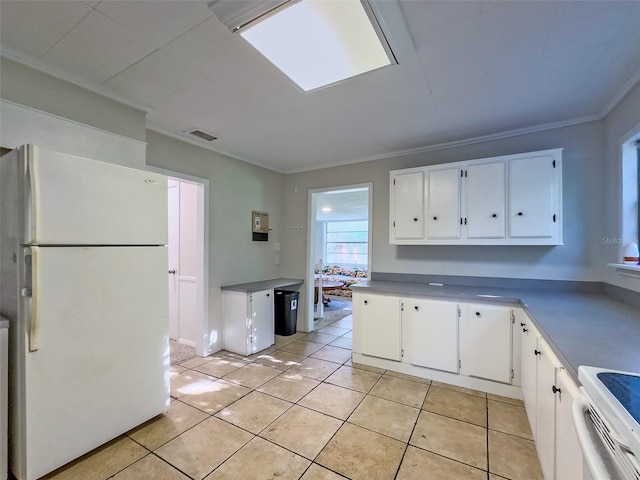 kitchen featuring white cabinetry, white appliances, ornamental molding, and light tile patterned floors