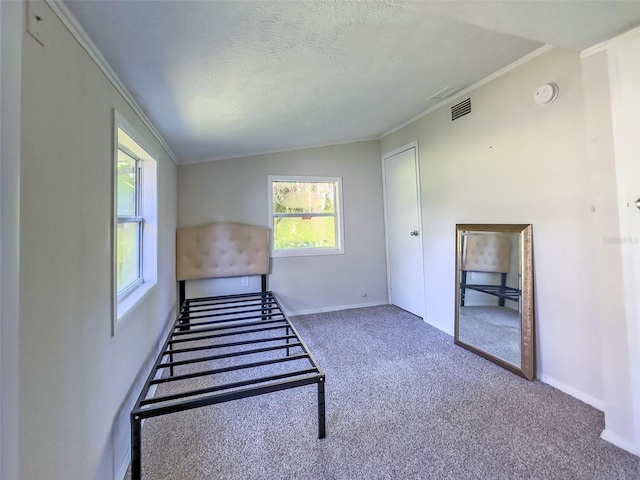 stairs with lofted ceiling, ornamental molding, a textured ceiling, and carpet