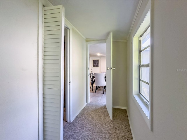 corridor with light carpet and crown molding