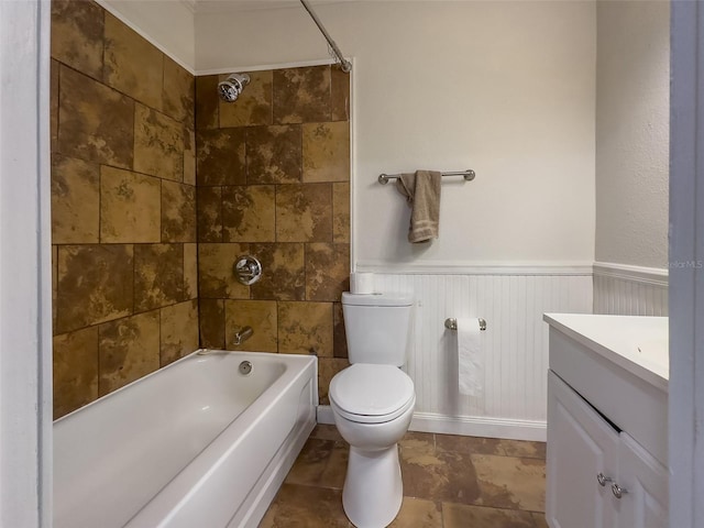 full bathroom with tiled shower / bath, vanity, and toilet