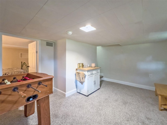 recreation room with light carpet