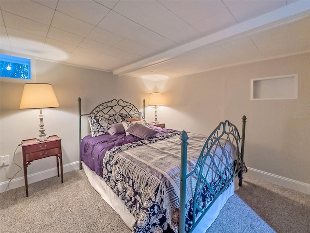 carpeted bedroom with beamed ceiling