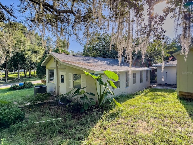 view of home's exterior featuring a yard and central AC unit