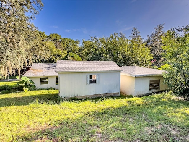 view of side of property with a lawn