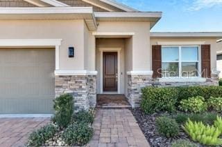 view of exterior entry with a garage