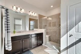 bathroom with vanity and tiled shower