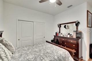 bedroom featuring ceiling fan and a closet