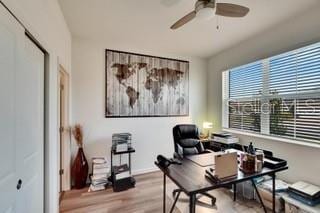 office space featuring ceiling fan and light hardwood / wood-style flooring