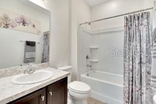 full bathroom featuring toilet, vanity, and shower / bathtub combination with curtain