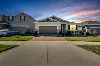 view of front of home featuring a garage and a yard