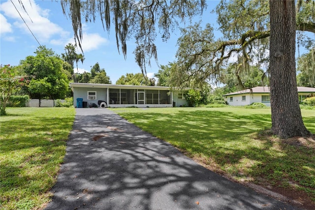 ranch-style home with a front lawn