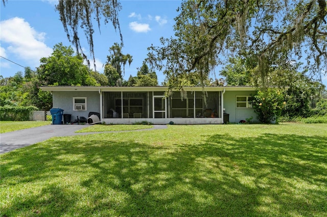 ranch-style home featuring a front yard