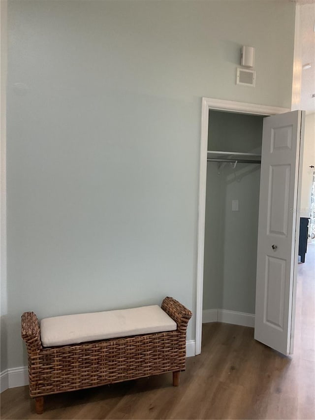 bedroom with wood-type flooring and a closet