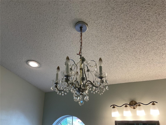 interior details with an inviting chandelier and a textured ceiling