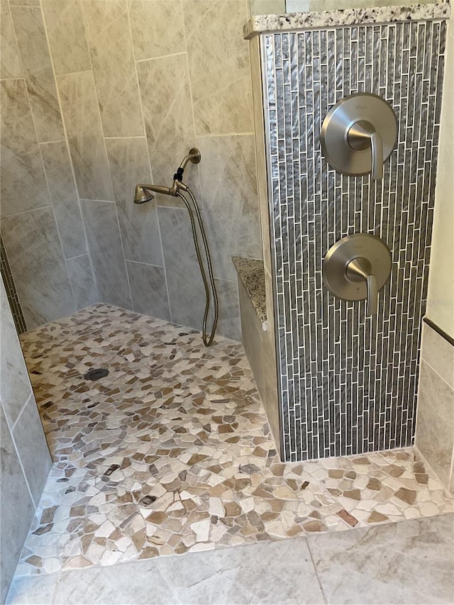 bathroom with tiled shower