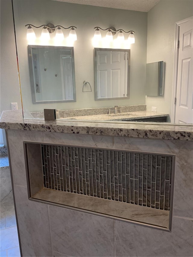 bathroom featuring vanity, a textured ceiling, and tile patterned flooring