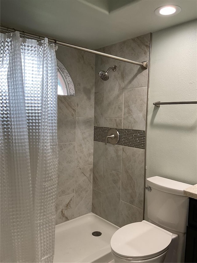 bathroom with toilet and a shower with shower curtain