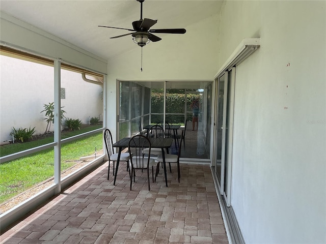 sunroom / solarium with lofted ceiling and ceiling fan