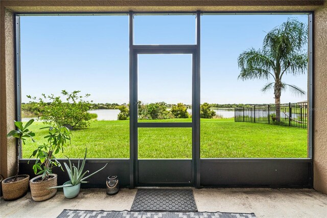 unfurnished sunroom with a water view