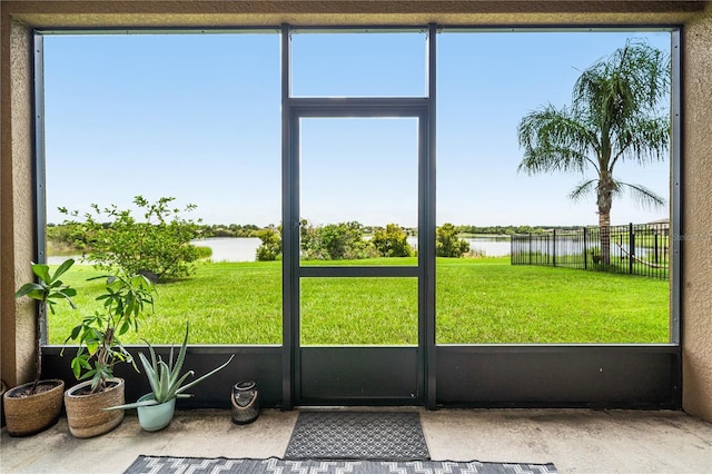 unfurnished sunroom featuring a water view