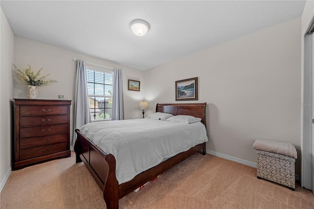 bedroom featuring light carpet