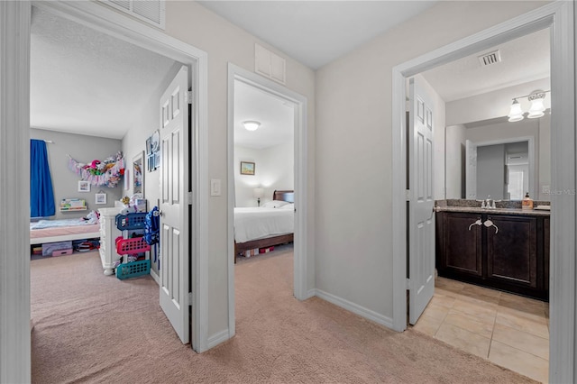 hall with light colored carpet