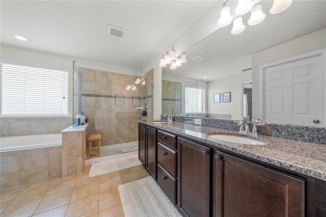 bathroom featuring shower with separate bathtub, tile patterned floors, a healthy amount of sunlight, and dual bowl vanity