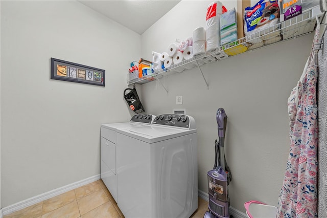 laundry room with washer and dryer and light tile patterned floors