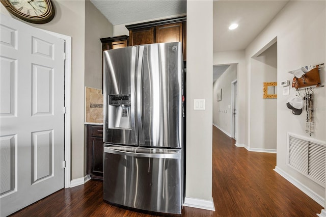 kitchen featuring dark hardwood / wood-style flooring, dark brown cabinets, and stainless steel fridge with ice dispenser