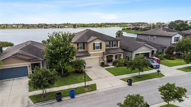 view of front of property featuring a water view and a front lawn