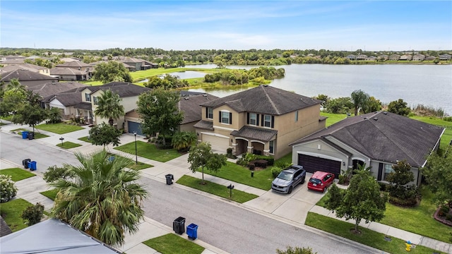 birds eye view of property with a water view