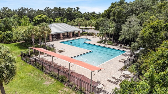 view of swimming pool with a patio and a lawn