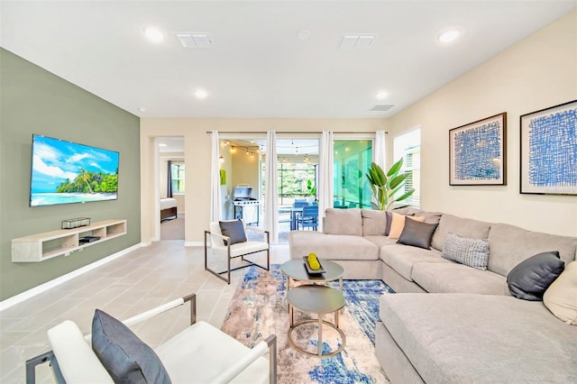 living room featuring a healthy amount of sunlight and light tile patterned floors