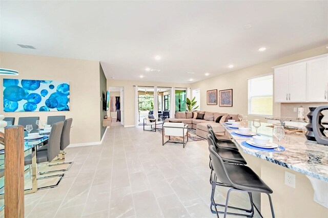 tiled dining space featuring french doors