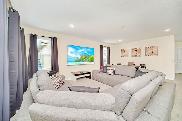 living room featuring light colored carpet and a wealth of natural light