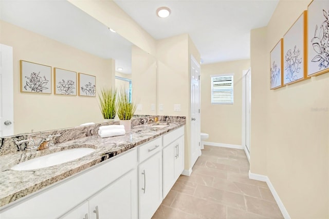 bathroom with dual vanity, tile patterned floors, toilet, and a shower with door