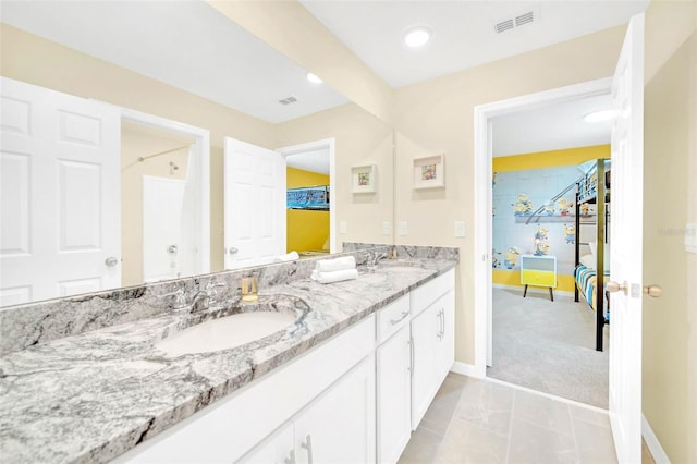 bathroom featuring tile patterned floors and double vanity