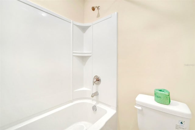 bathroom featuring shower / bathtub combination and toilet