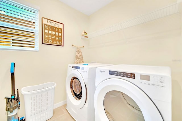 laundry area featuring washer and clothes dryer and light tile patterned floors