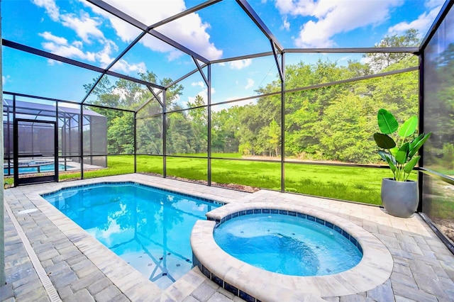 view of pool with an in ground hot tub, a lanai, a patio area, and a yard