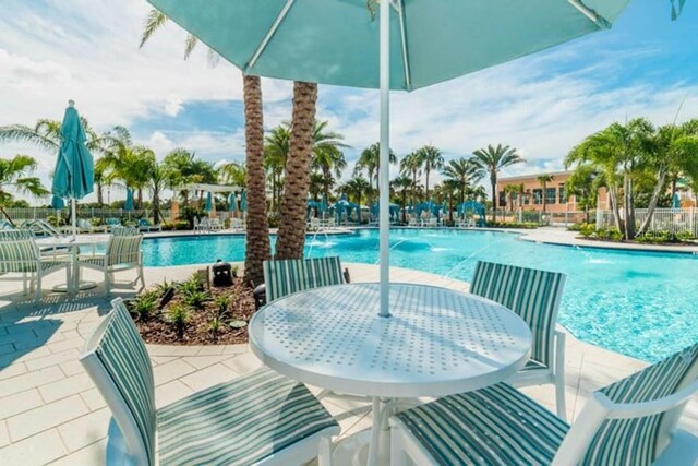 view of pool featuring pool water feature and a patio area