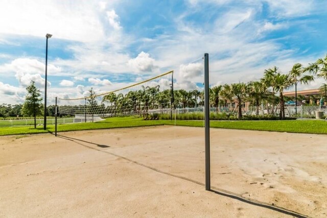 view of property's community featuring a lawn and volleyball court