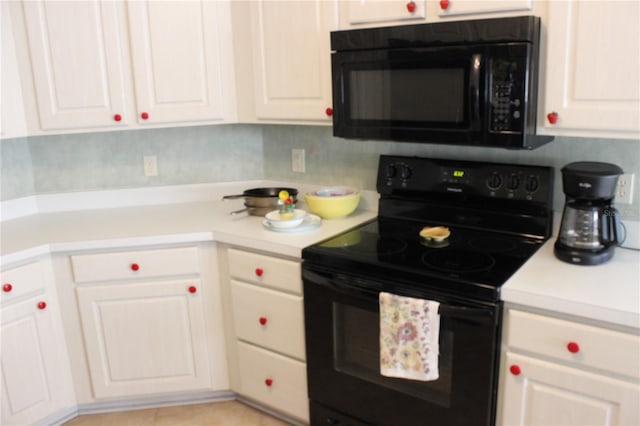 kitchen with black appliances, decorative backsplash, and white cabinets