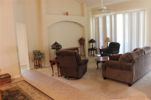 living room with high vaulted ceiling, ceiling fan, and tile patterned floors