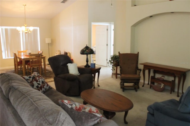 living room featuring carpet floors, high vaulted ceiling, and a chandelier