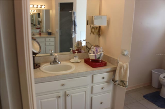 bathroom featuring vanity, toilet, and tile patterned floors